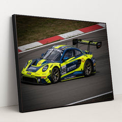 This photo shows a blue and yellow Porsche race car numbered 96 on a racetrack, in a black frame.