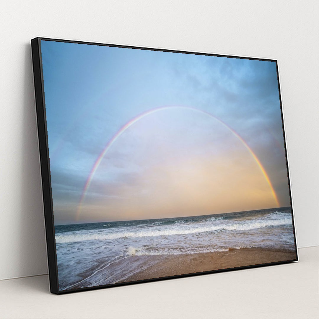 Rainbow Arching Over Ocean Waves at Golden Hour by Ben Mack - Black Frame Stretchiez