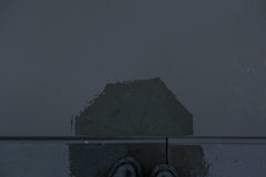 Beyzaa Yurtkuran - Reflection Of Umbrella In Water On A Rainy Day