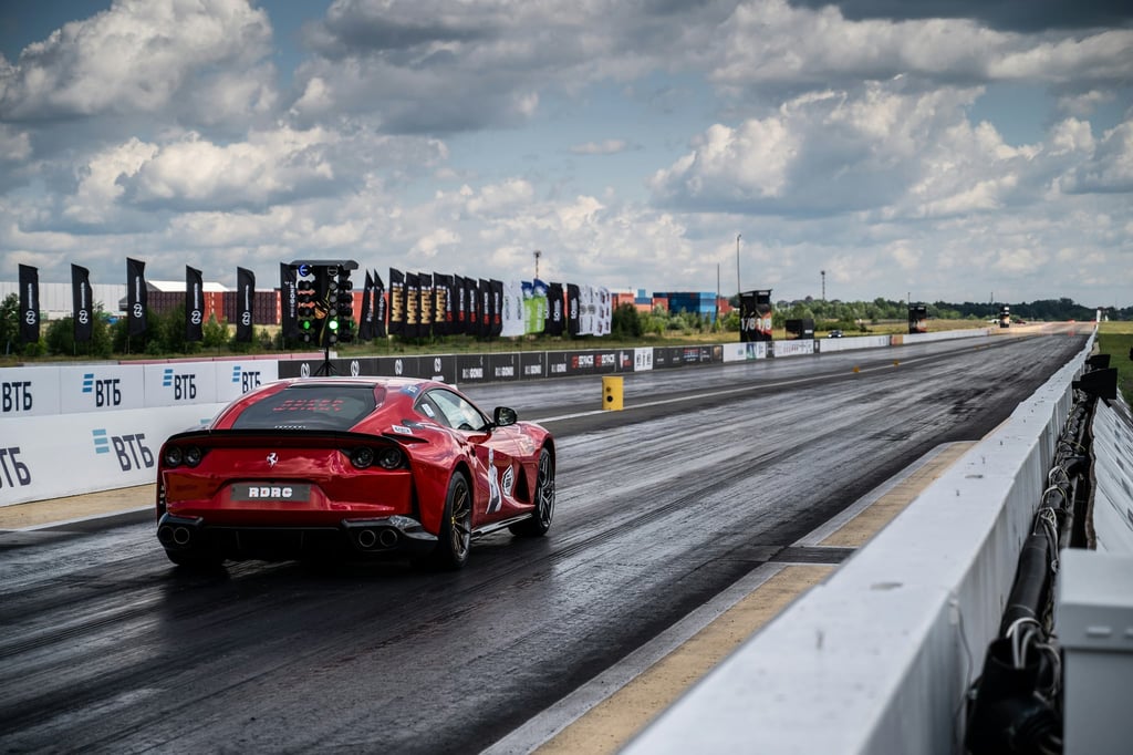Ferrari 812 Superfast Drag Strip racing down the track, showcasing car wall art under dynamic clouds.