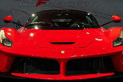 Ferrari LaFerrari Front and Center, showcasing aggressive design in Rosso Corsa red with a modern background, ideal car wall art.