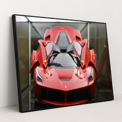 This photo shows a red Ferrari LaFerrari with scissor doors open, displayed indoors under soft lighting, in a black frame.