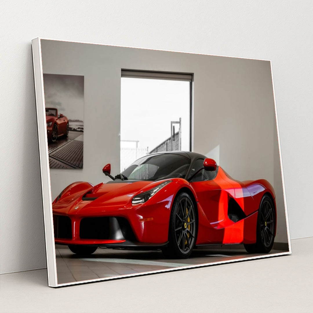 This photo shows a red Ferrari LaFerrari coupe displayed in a bright, modern showroom, in a white frame.