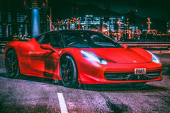 Ferrari 458 Italia Amid City Lights, showcasing its glossy red finish and sleek design under urban lights.
