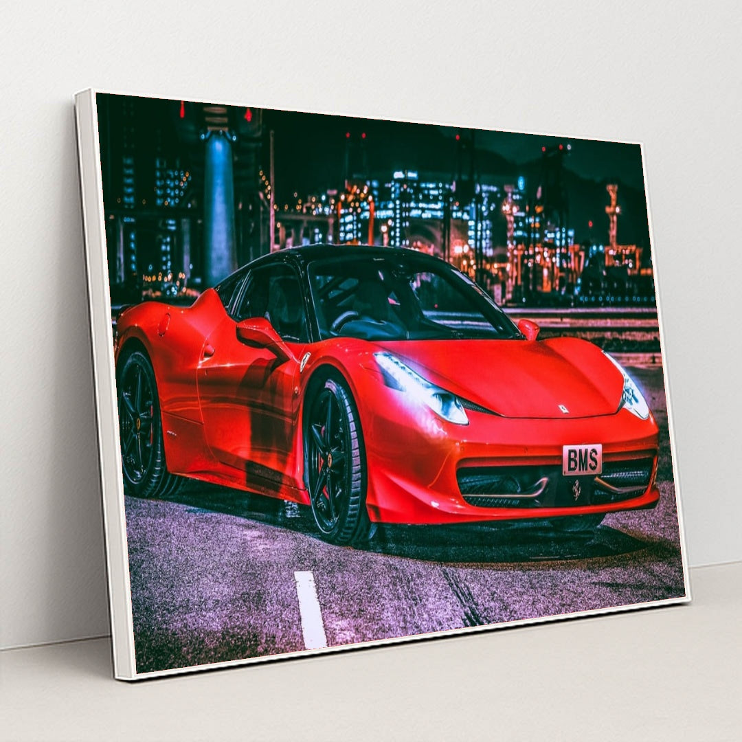 This photo shows a red Ferrari 458 Italia with black wheels parked under city lights at night, in a white frame.