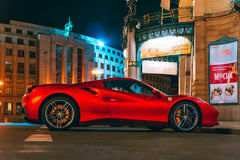 Ferrari 488 GTB Glowing Red parked at night in a vibrant urban square, showcasing car wall art with sleek design.