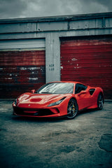 Ferrari F8 Tributo in the City's Grit, parked against a gritty industrial backdrop with bold textures and peeling paint.