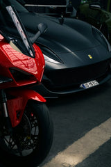 Ferrari vs. Superbike in a dimly lit industrial setting, showcasing Italian engineering in car wall art.