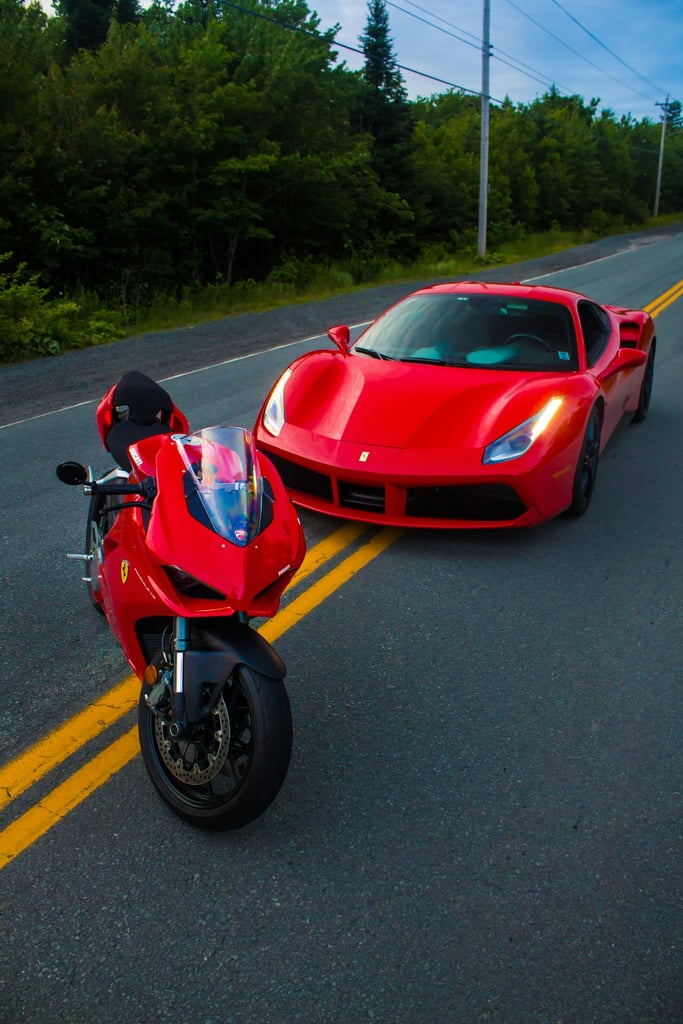 Ducati and Ferrari on the Road featuring a red Ducati superbike and Ferrari 488 GTB on a country road.