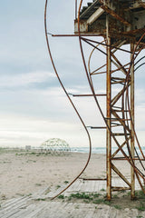 Mikhail Nilov - A deserted beach with a rusty metal structure, perfect for industrial decay themes.