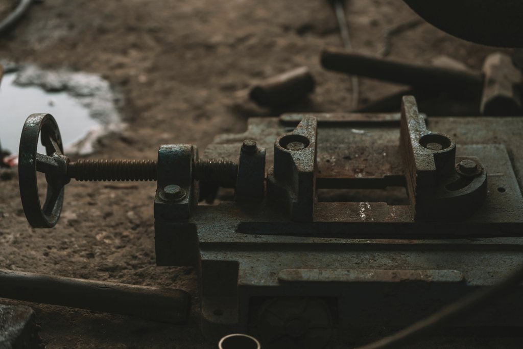 Tahamie Farooqui - Close-up of rusty industrial tools in a workshop setting, emphasizing craftsmanship.