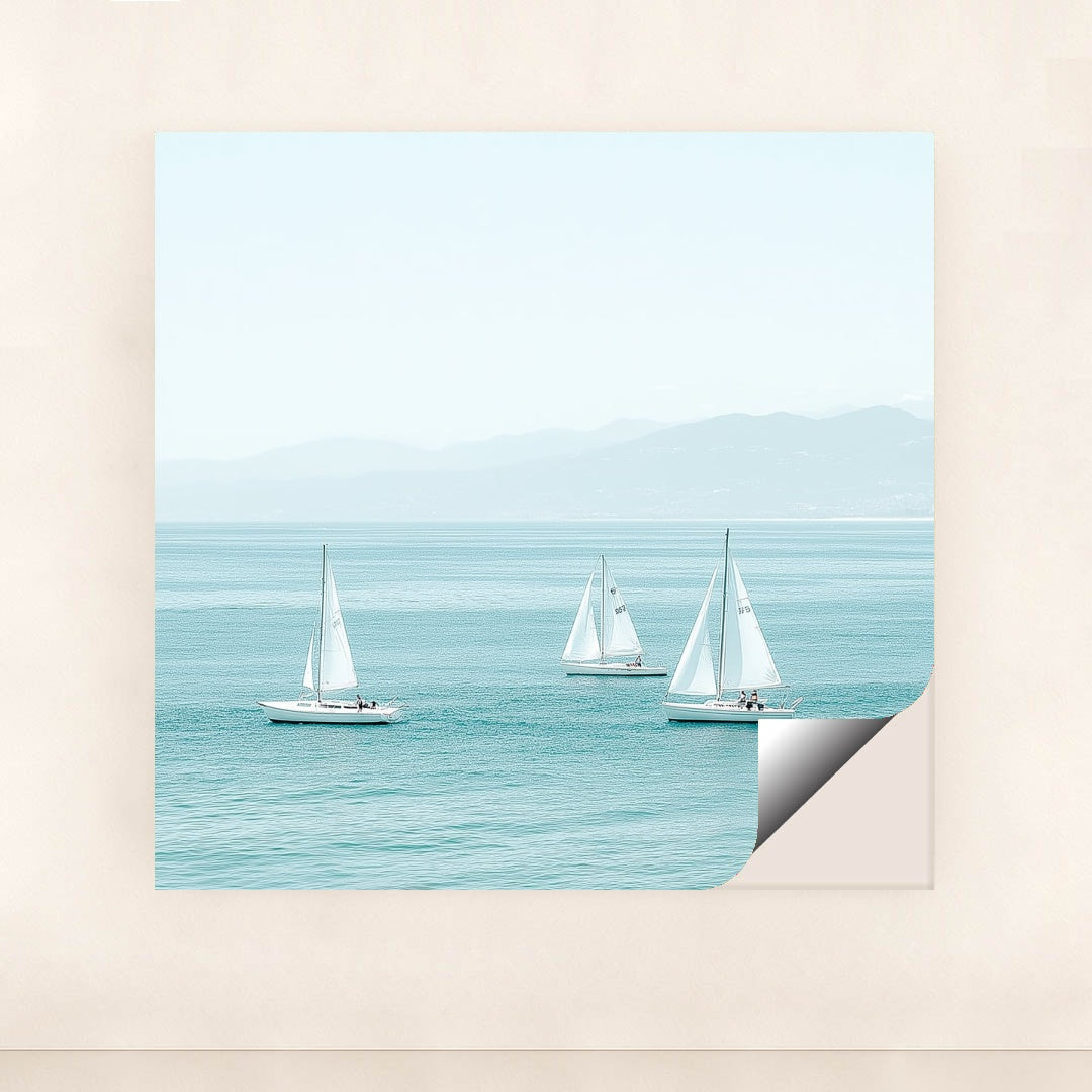 This artwork shows three white sailboats on calm turquoise water with mountains in the distance, unframed.