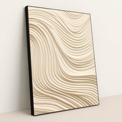 This artwork features smooth, wavy lines of textured tan sand in an abstract pattern, in a black frame.