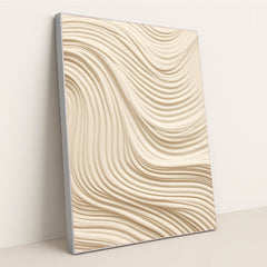 This artwork features smooth, wavy lines of textured tan sand in an abstract pattern, in a silver frame.