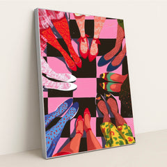 This artwork shows a circle of people with brightly patterned shoes and stockings standing on a pink and black checkerboard floor, in a silver frame.