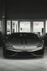 Lamborghini Stare Down - Matte gray Lamborghini supercar showcased in a modern showroom, exemplifying car wall art.