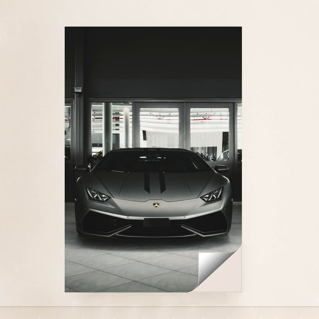 This photo shows the front view of a matte grey Lamborghini Huracán parked indoors, unframed.