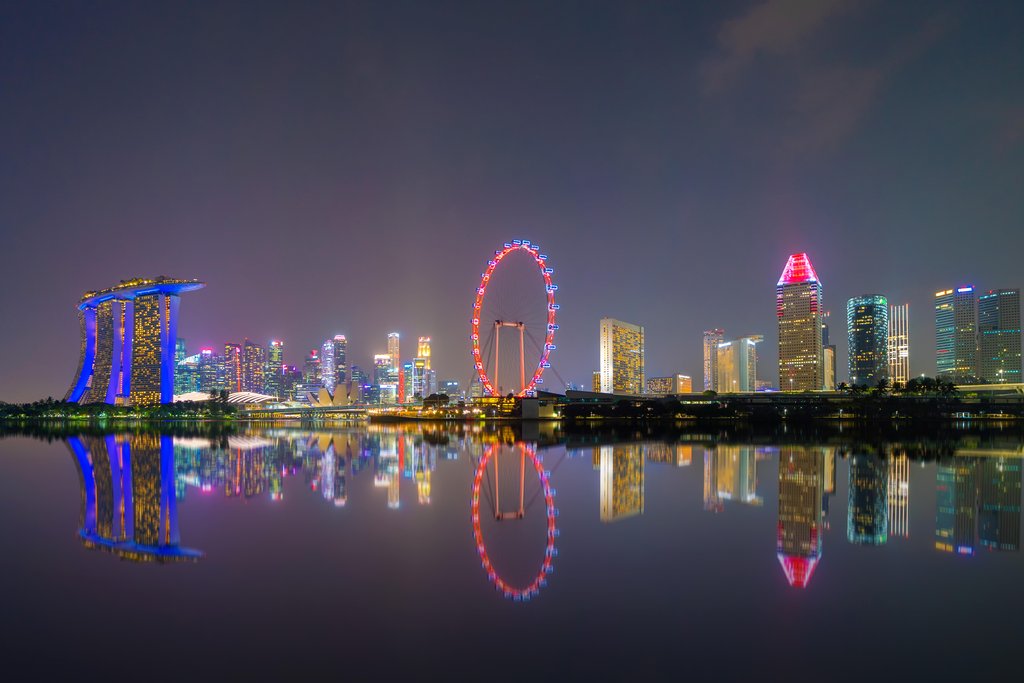 Stock Photos - Singapore Downtown skyline at night with reflection. Financial district and business centers in technology smart urban city in Asia. Skyscraper and high-rise buildings.