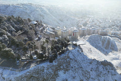Unknown - Aerial view of √áankƒ±rƒ±, T√ºrkiye, covered in snow, showcasing urban and natural landscapes.