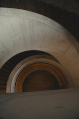 Joshua Roberts - A captivating view of a modern spiral staircase showcasing architectural elegance indoors.