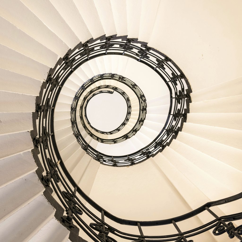 Wolfgang Weiser - Abstract view of a spiral staircase with elegant design in Hamburg.