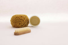 Cup of  Couple - A natural sponge, brush, and skincare cream arranged for a minimalist spa setting.