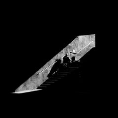 Arman - Dramatic black and white photo of people in silhouette on a staircase.