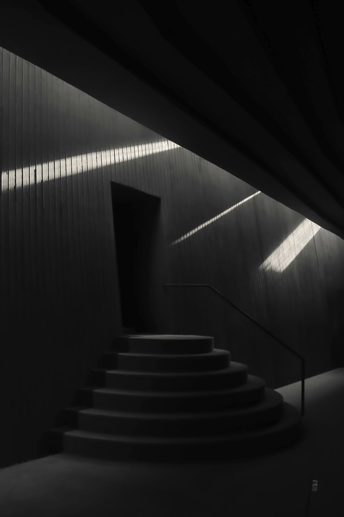 taha balta - Artistic black-and-white photo of a modern staircase with dramatic lighting.