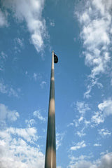 Andres Villamizar - A striking tall sculpture reaching into a blue sky with clouds, captured in Bucaramanga, Colombia.