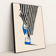 This artwork shows black and white striped pants and blue pointed shoes stepping on a pale background, in a black frame.