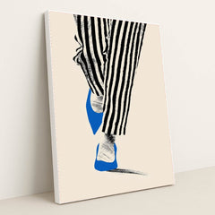 This artwork shows black and white striped pants and blue pointed shoes stepping on a pale background, in a white frame.