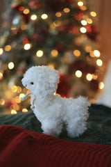 Valeria Boltneva - Adorable llama toy in front of a brightly lit Christmas tree, creating a festive holiday ambiance.