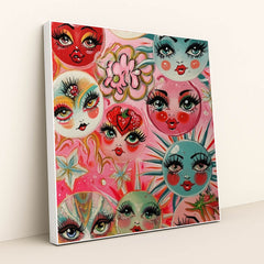 This artwork shows whimsical painted faces with large lashes and bright lips on colorful circles, surrounded by flowers and stars, in a white frame.