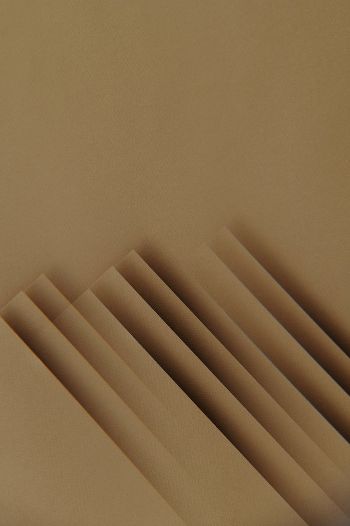 Edward Jenner - A minimalist abstract composition featuring layers of beige paper in a vertical arrangement.