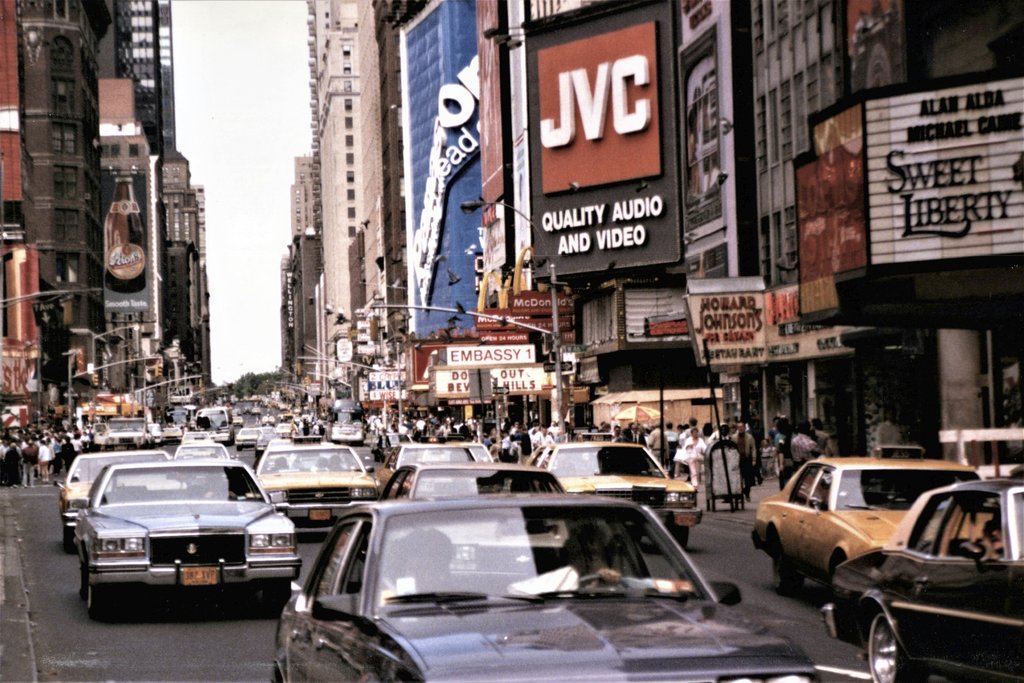 Ted McDonnell - A bustling scene of vintage cars and iconic billboards in Times Square.