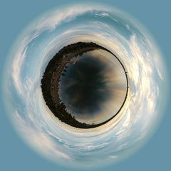 Josh Sorenson - A stunning tiny planet view of a city skyline with a vivid, dramatic sky.