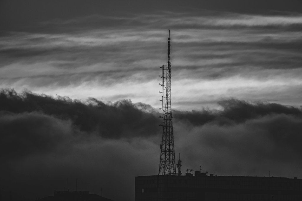 Anderson Santos - Black and white image of an antenna tower against a dramatic cloudscape in São Paulo, Brazil.