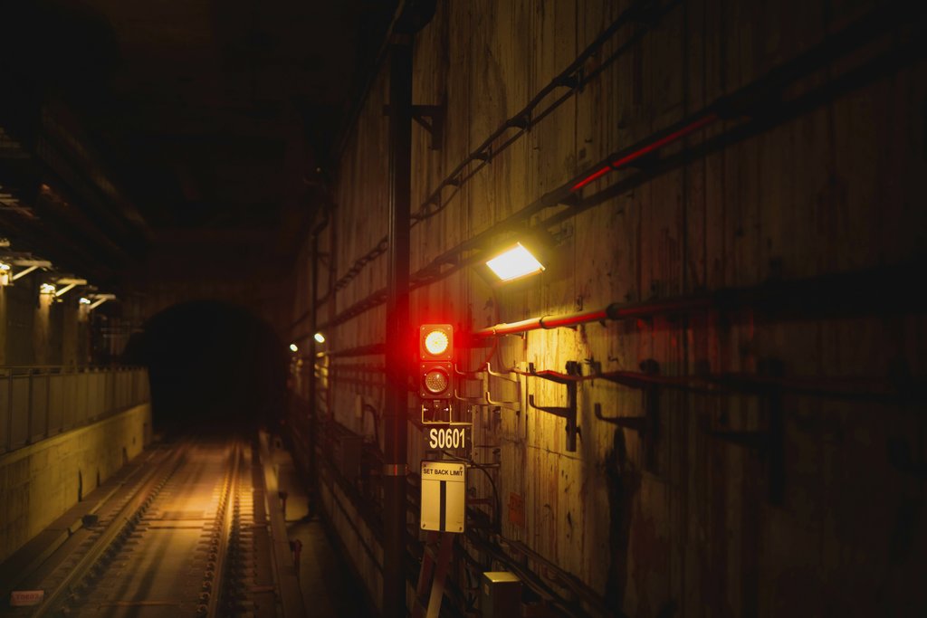 Subway Shadows: Red Signal Light by YIYANG LIU