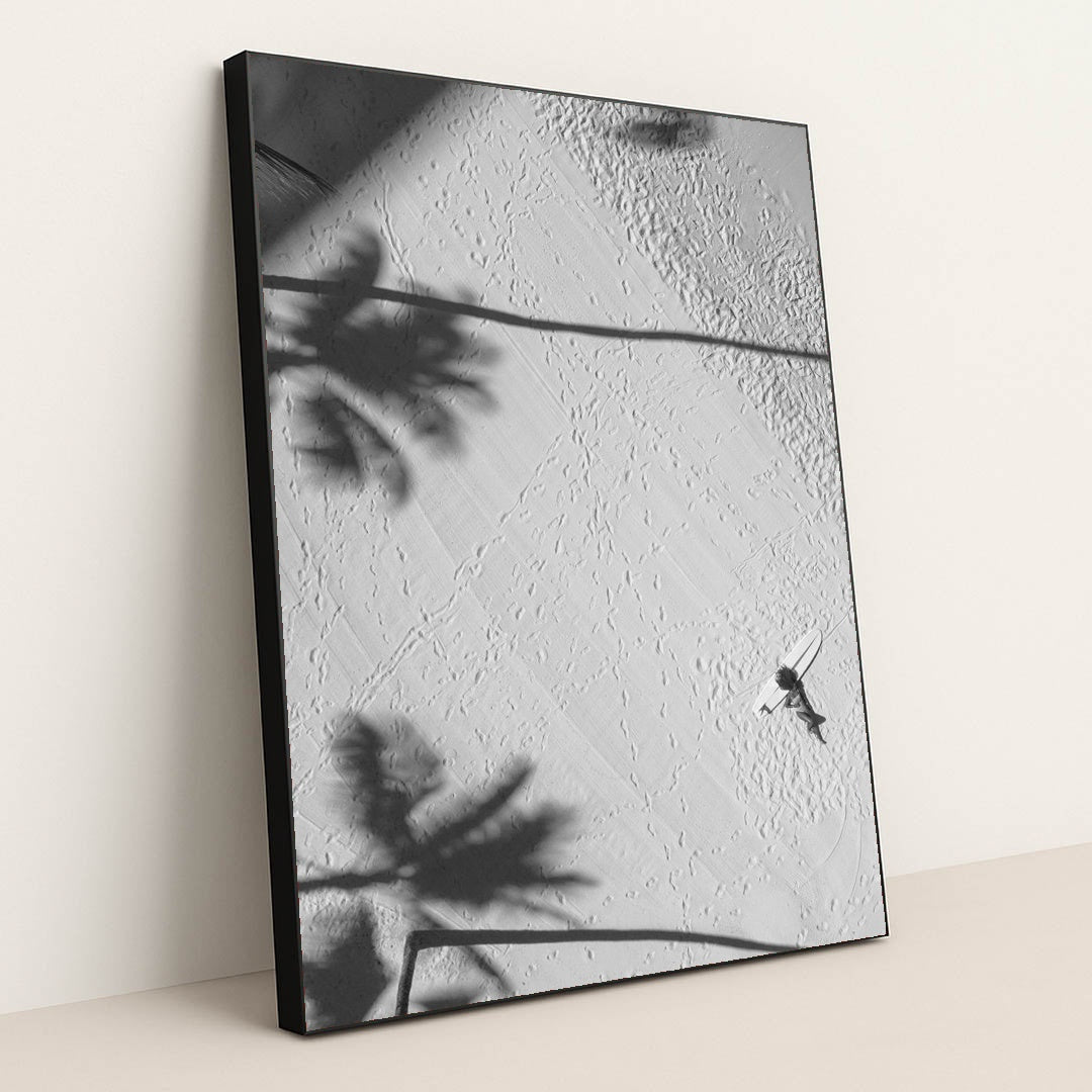 Lying by a surfboard on the beach under palm shadows by Jess Loiterton - Black Frame Stretchiez