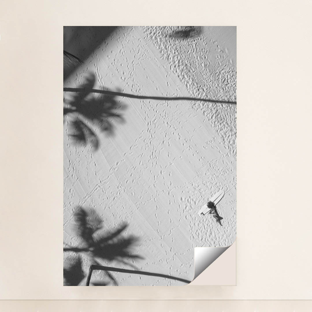 Lying by a surfboard on the beach under palm shadows by Jess Loiterton - Peeliez