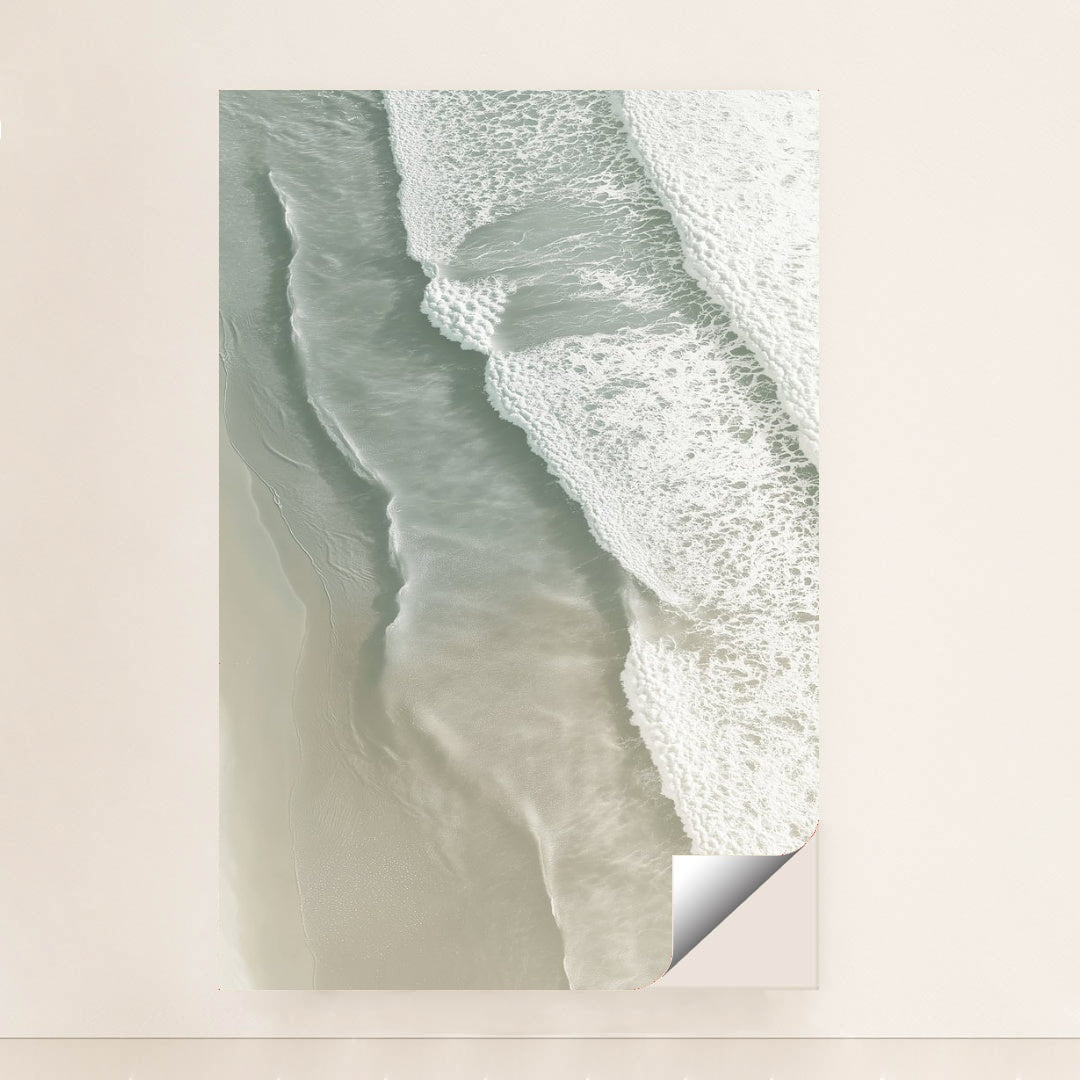 This artwork shows soft ocean waves washing onto smooth sand from above, unframed.