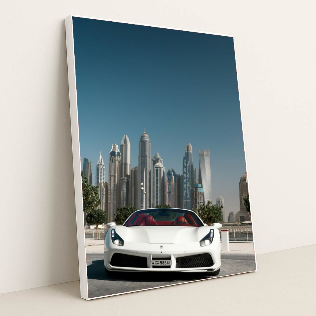 This photo shows a white Ferrari convertible with red seats parked in front of Dubai skyscrapers under a clear blue sky, in a white frame.