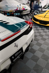 Ferrari Showroom Elegance showcasing a white Ferrari sports car and a yellow Ferrari in a luxury garage setting. Car wall art.