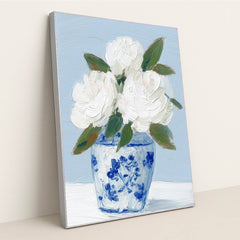 This artwork features white textured flowers in a blue and white vase painted with thick brushstrokes, in a silver frame.