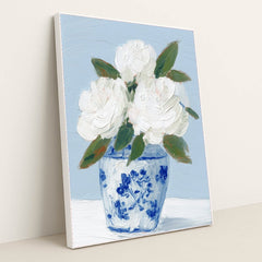 This artwork features white textured flowers in a blue and white vase painted with thick brushstrokes, in a white frame.