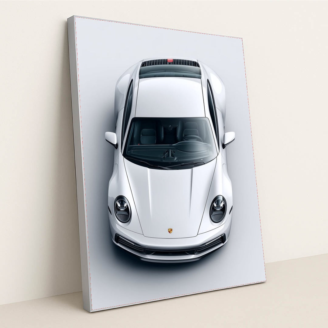 This photo shows a top-down view of a white Porsche 911 against a light gray background, in a silver frame.