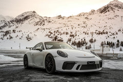 Porsche 911 Parked in the Mountains against a snowy backdrop, showcasing car wall art with luxury and nature.