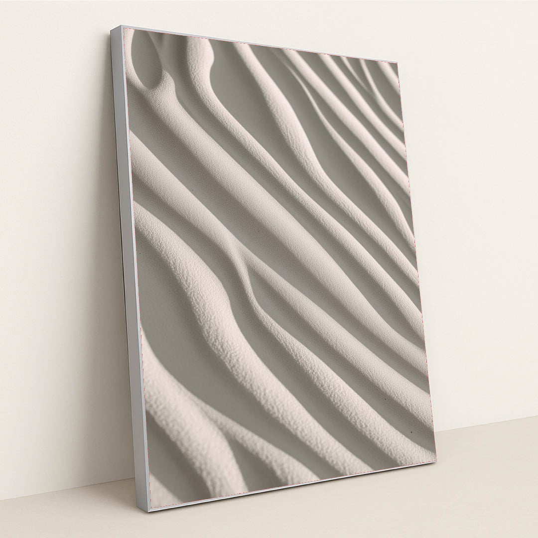 This artwork shows smooth, wavy lines of pale sand in soft sunlight, in a silver frame.