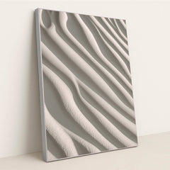 This artwork shows smooth, wavy lines of pale sand in soft sunlight, in a silver frame.