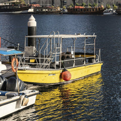 aboodi vesakaran - A vibrant yellow boat docked at a busy marina harbor in Dubai, United Arab Emirates.